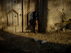 Little Kid Standing in the Door at Dusk